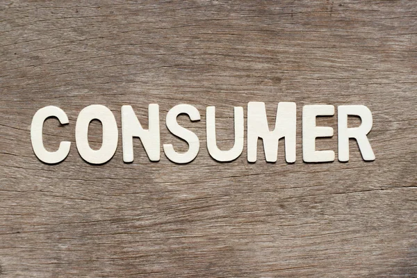 Ahşap arka plan üzerinde kelime tüketici mektupta alfabesi