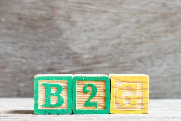 Color letter block in word b2g (abbreviation of business to government) on wood background