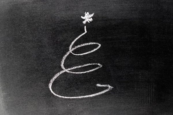 White chalk hand drawing in spiral or christmas tree in line shape on blackboard background