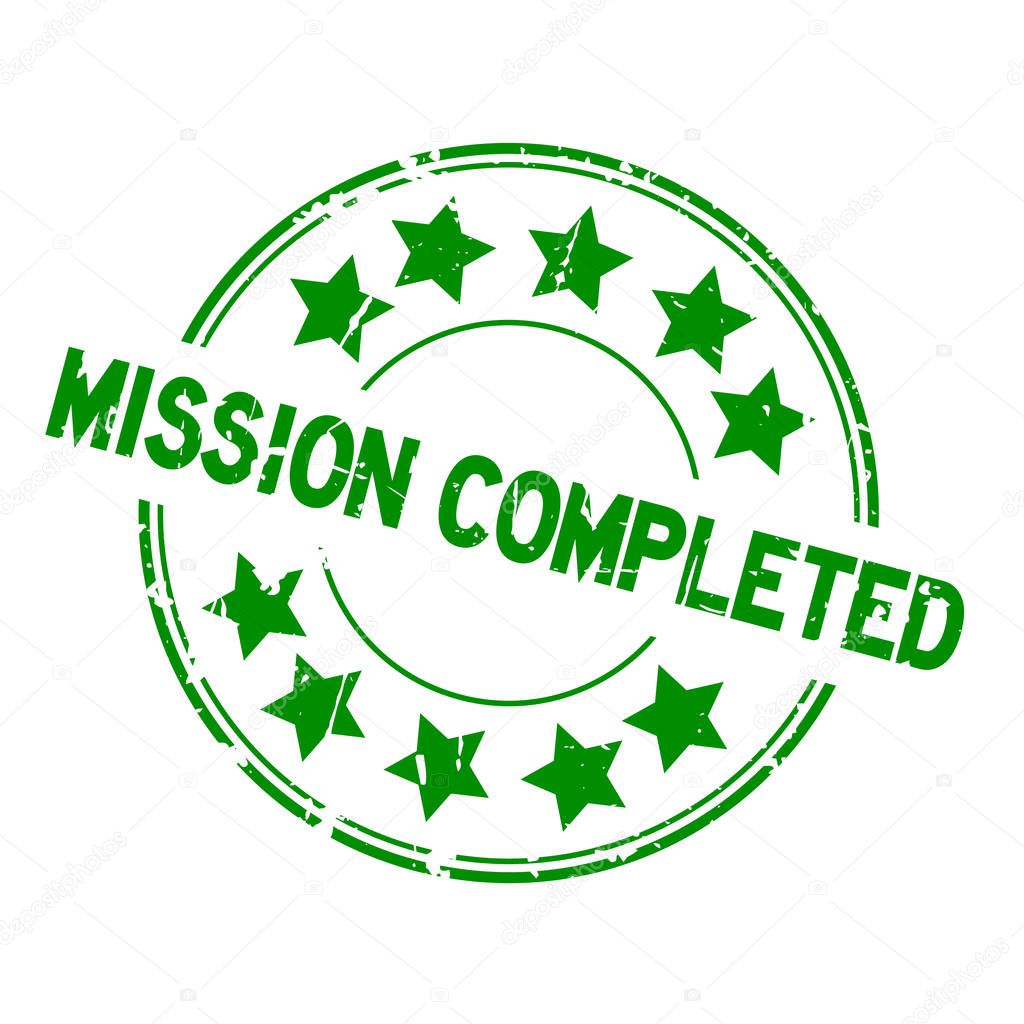 Grunge green mission completed with star icon round rubber seal stamp on white background