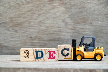 Oyuncak forklift tutun blok c tamamlamak için ahşap arka plan (takvim tarih 3 ay Aralık için konsept üzerine 3 Aralık kelime)
