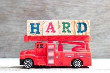 Oyuncak itfaiyenin merdiveni tutun mektup blok Word'de sert ahşap zemin üzerine