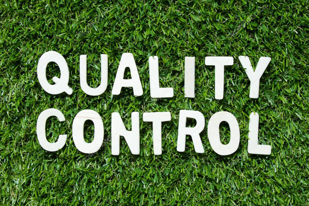 Alphabet letter in word quality control on artificial green grass background