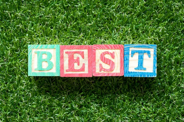 Color Wood Block Word Best Artificial Green Grass Background — Stock Photo, Image