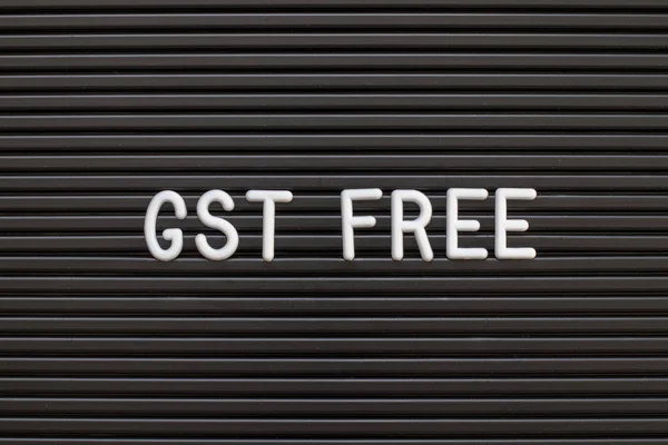 Black color felt letter board with white alphabet in word GST (Abbreviation of Goods and Service Tax) free background