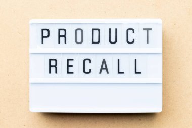 White lightbox with word product recall on wood background clipart