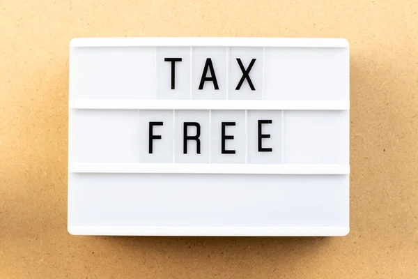 Light box with word tax free on wood background