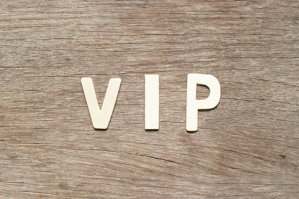 Alphabet letter in word VIP (abbreviation of very important person) on wood background