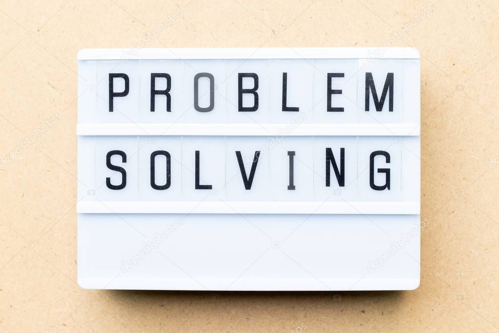 White lightbox with word problem solving on wood background
