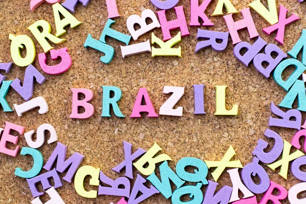 Color alphabet in word brazil with another letter as frame on cork board background — Stock Photo, Image