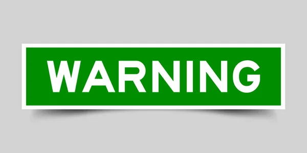 Etichetta adesiva verde quadrato in avvertimento parola su sfondo grigio — Vettoriale Stock