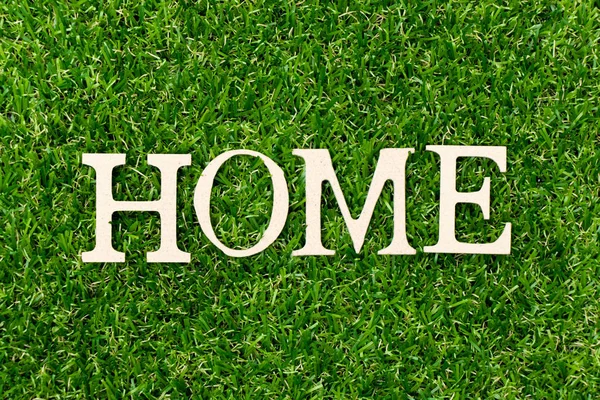 Wood letter in word home on green grass background — 스톡 사진