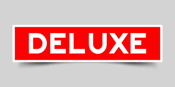 Aufkleber in roter Farbe quadratisch als Wort deluxe auf weißem Hintergrund — Stockvektor