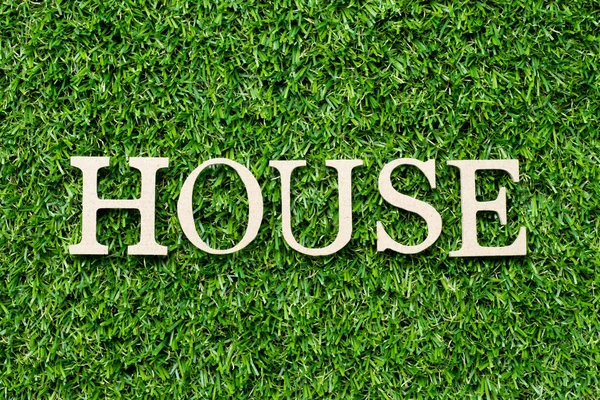 Wood alphabet letter in word house on green grass background — Stock Photo, Image