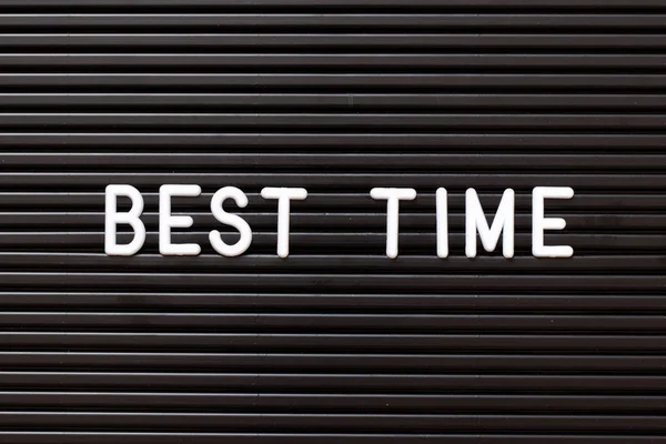 Black color felt letter board with white alphabet in word best time background