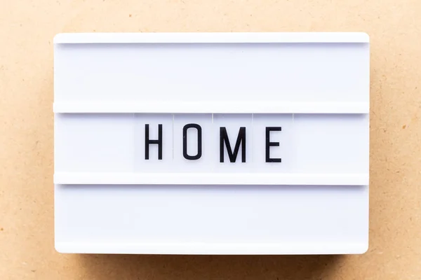 Lightbox with word home on wood background — Stock Photo, Image