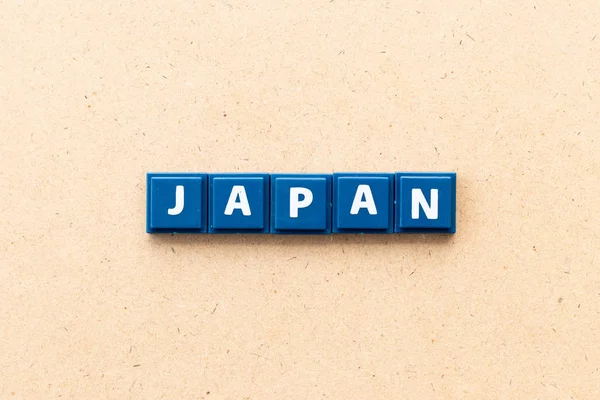 Tegel letter in Word Japan op hout achtergrond — Stockfoto