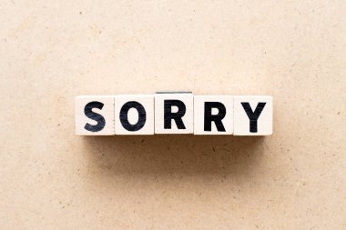 Letter block in word sorry on wood background clipart