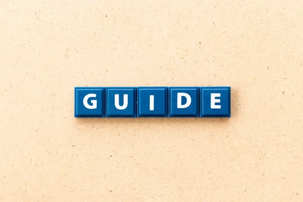 Tile letter in word guide on wood background — Stock Photo, Image