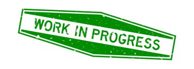 Grunge yeşil çalışma devam ederken kelime altıgen lastik mühür beyaz arka planda