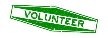 Grunge yeşil gönüllü kelime altıgen lastik mühür beyaz arka planda