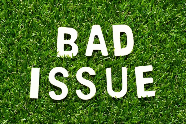 Wood alphabet letter in word bad issue on green grass background
