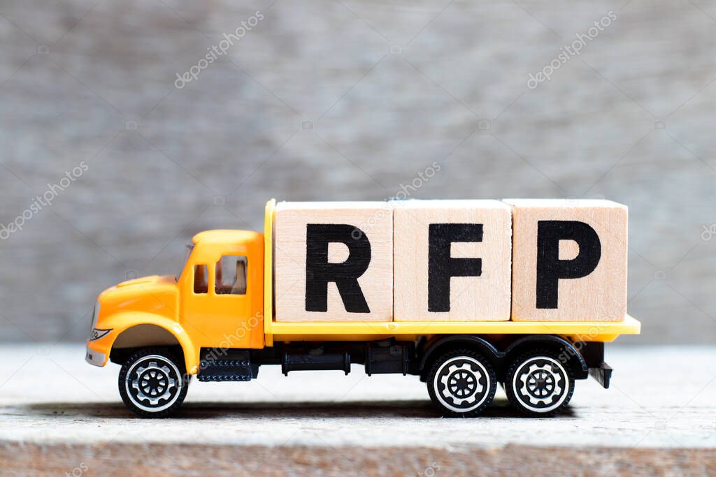 Truck hold letter block in word RFP (Abbreviation of request for proposal) on wood background