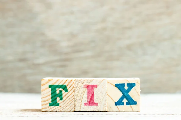 Alphabet letter in word fix on wood background