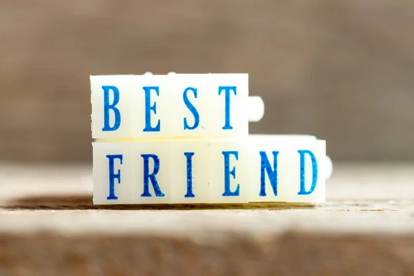 Letter block with blue color word best friend on wood background