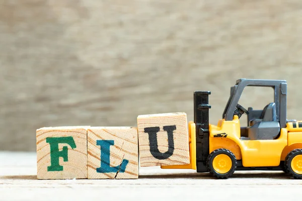 Spielzeug Gabelstapler Halten Buchstabe Block Wort Grippe Auf Holz Hintergrund — Stockfoto
