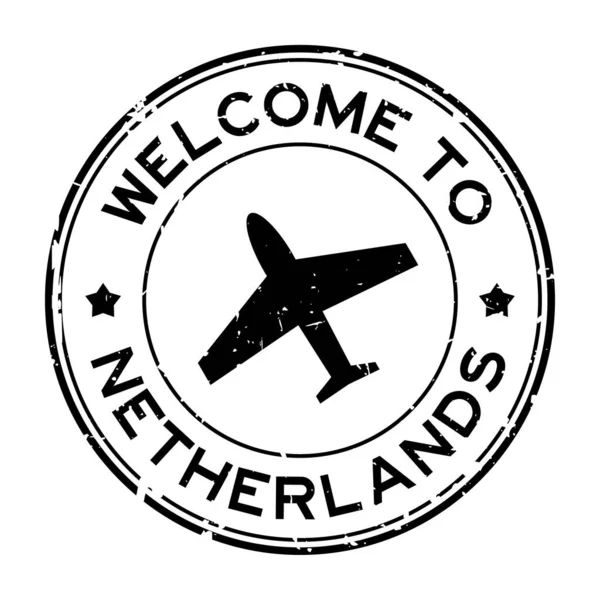 白い背景に飛行機のアイコンの丸いゴムシールスタンプとオランダ語の単語へのGrunge黒歓迎 — ストックベクタ