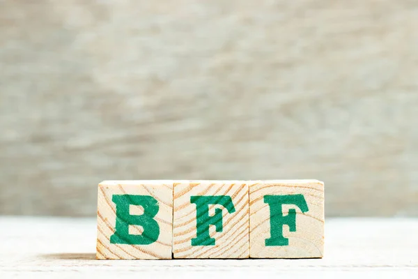 Alphabet letter in word BFF (Abbreviation of best friend forever) on wood background