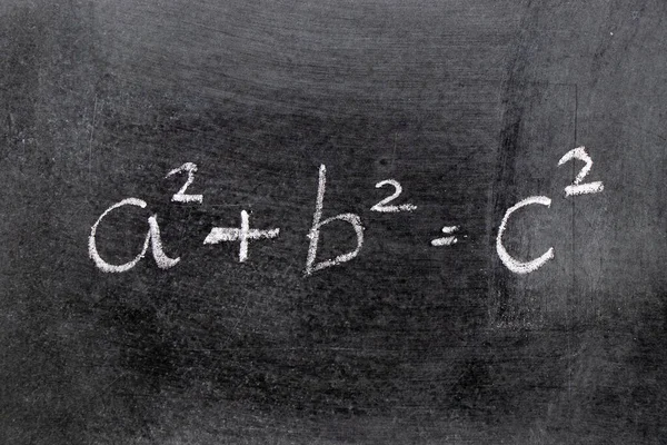 White color chalk hand writing in mathematics formula (Pythagorean theorem or Pythagoras\'s theorem) on blackboard background