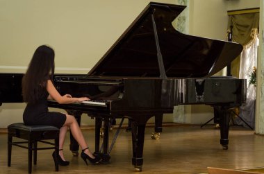 Genç çekici esmer kız piyano