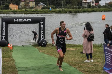 Ukrayna, Lviv - Eylül 2018: Bir atlet takım elbiseli hidro-sudan yüzdükten sonra bir triatlon yarışma sırasında çalışır
