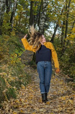 Uzun saçlı Genç güzel kız sonbahar Ormanda yürür