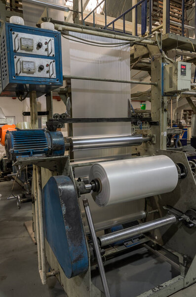 LVIV, UKRAINE - NOVEMBER 2018: Large industrial machine for the production of plastic bags at the factory