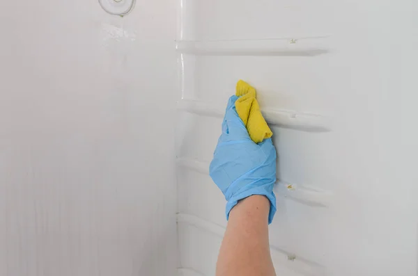 Housekeeper cleans the refrigerator inside