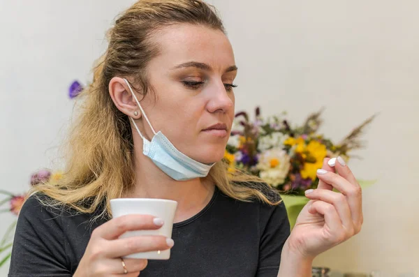 Young Woman Drinking Pill Removing Protective Medical Mask Her Chin — Stock Photo, Image
