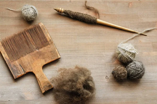 Ancient female craft tools on brown wooden background