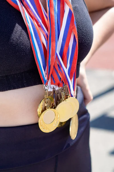 Woman has medals hanging on her chest — Stock Photo, Image