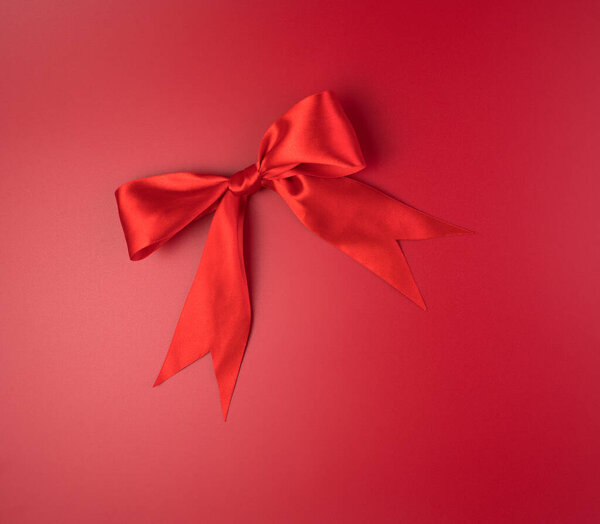 Large red bow on a red background.