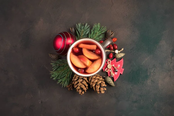 Beautiful Christmas composition with a Cup of mulled wine surrounded by Christmas decorations on a brown concrete background. Holiday background. — Stock Photo, Image