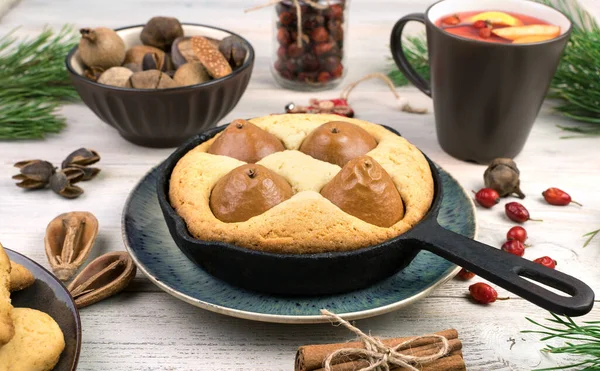 Christmas background with a pie with pears, Christmas toys and a blue napkin. — Stock Photo, Image