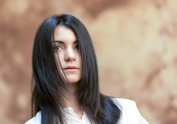 portrait of beautiful dark-haired girl with long hair blowing in the wind. High quality pportrait of beautiful dark-haired girl with long hair blowing in the windhoto