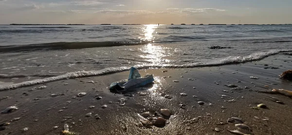 anti covid 19 surgical mask abandoned on the italian beach riccione refusal. High quality