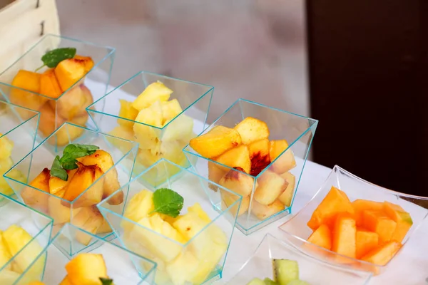 fruit buffet with single portions and cut fruit melon peach apple pear kiwi grape. High quality photo