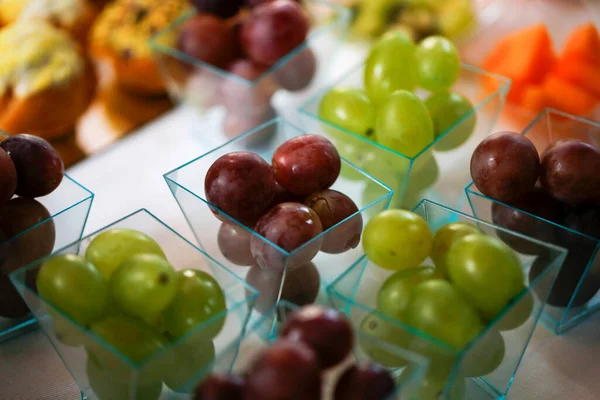 fruit buffet with single portions and cut fruit melon peach apple pear kiwi grape. High quality photo