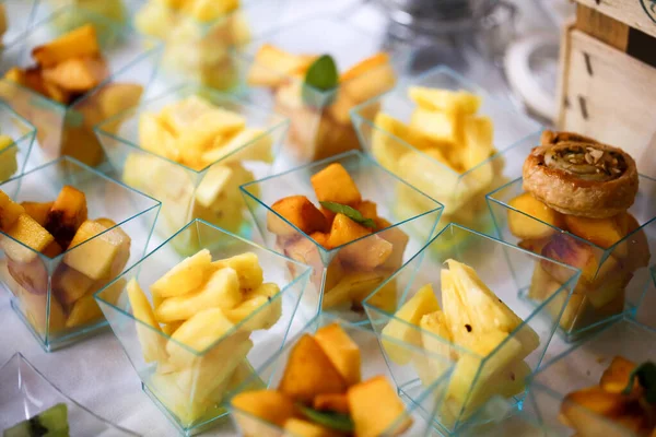 fruit buffet with single portions and cut fruit melon peach apple pear kiwi grape. High quality photo