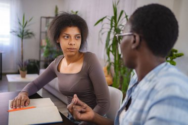 Young woman receiving psychological support from therapist during a session at home